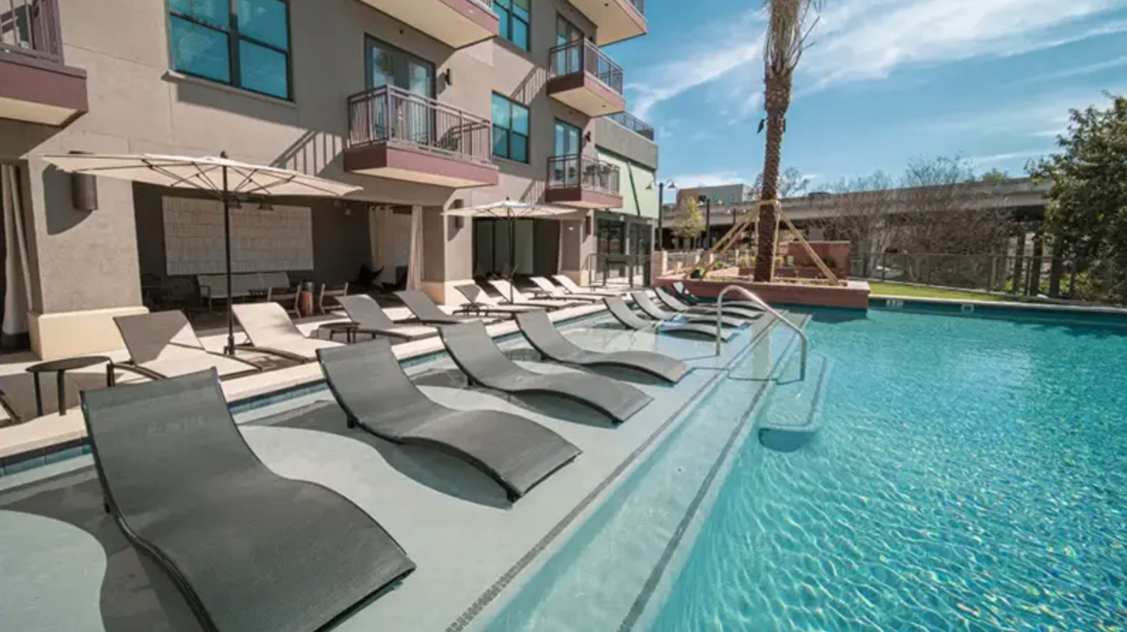 Resort-style pool with lounge seating